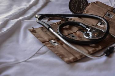 Black stethoscope with brown leather case