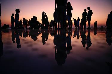 Picture of different age people at sunset